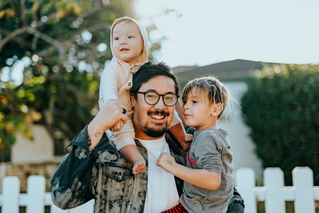 Father holding their kids with happy smile 