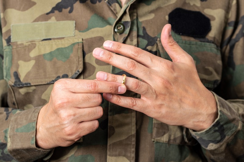 Person in the military removing a wedding ring for a military divorce in Ogden, UT