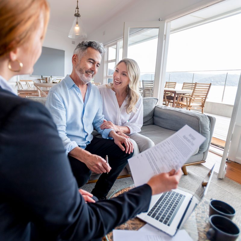 Advisor meeting with two people reviewing documents at a table in Ogden, Utah