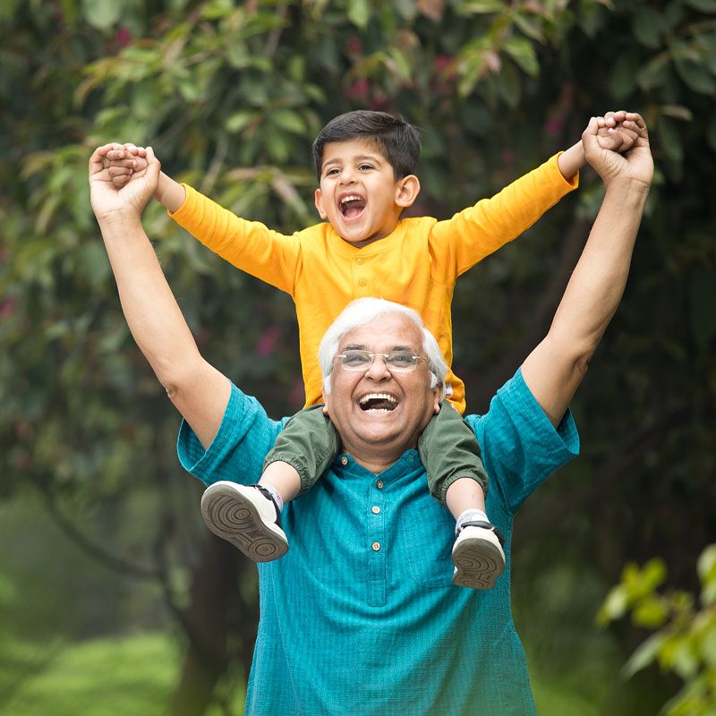 Grandparent lifting child outdoors, symbolizing family bond and grandparents' rights in Ogden, Utah